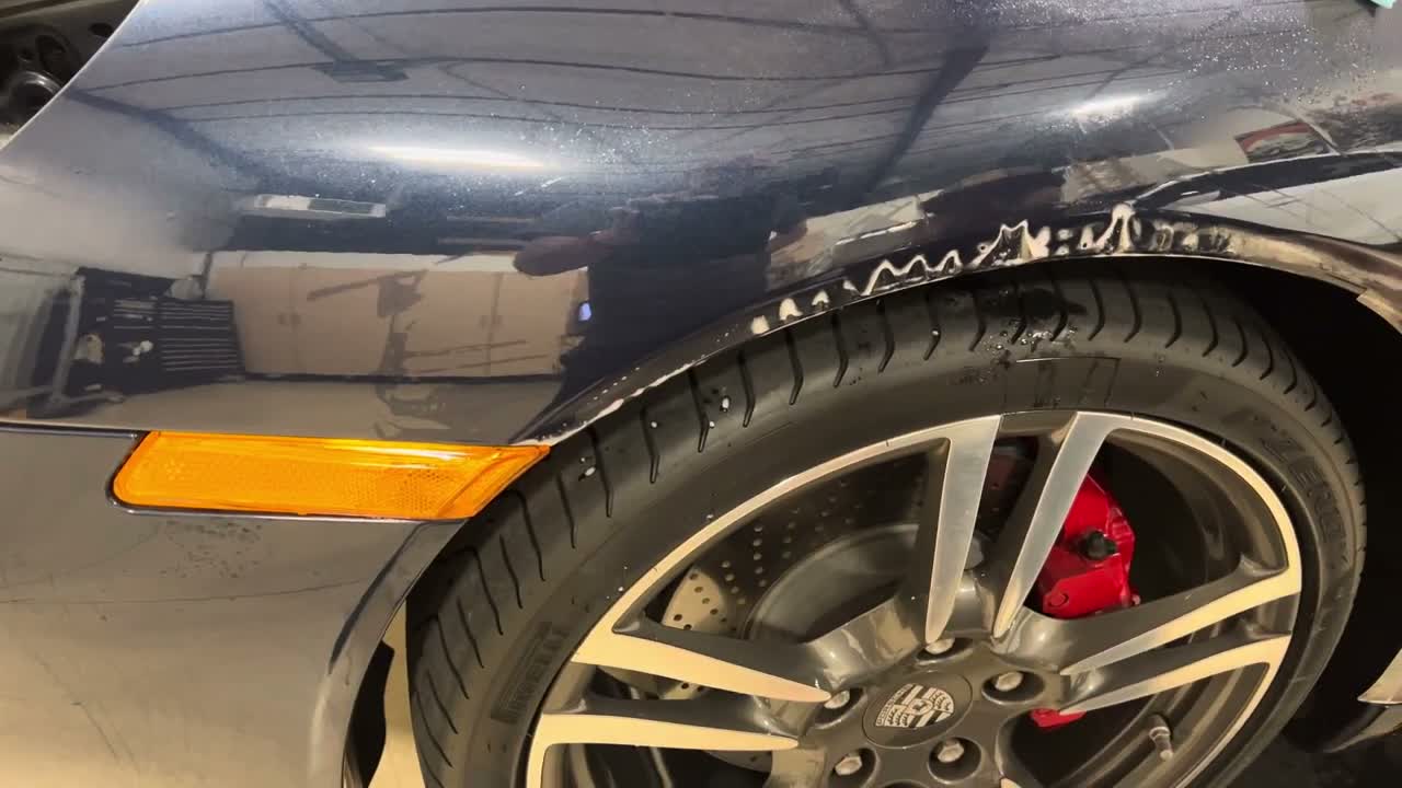 Dry the surface and inspect the edges Inspecting PPF fit along the Porsche front fender edge