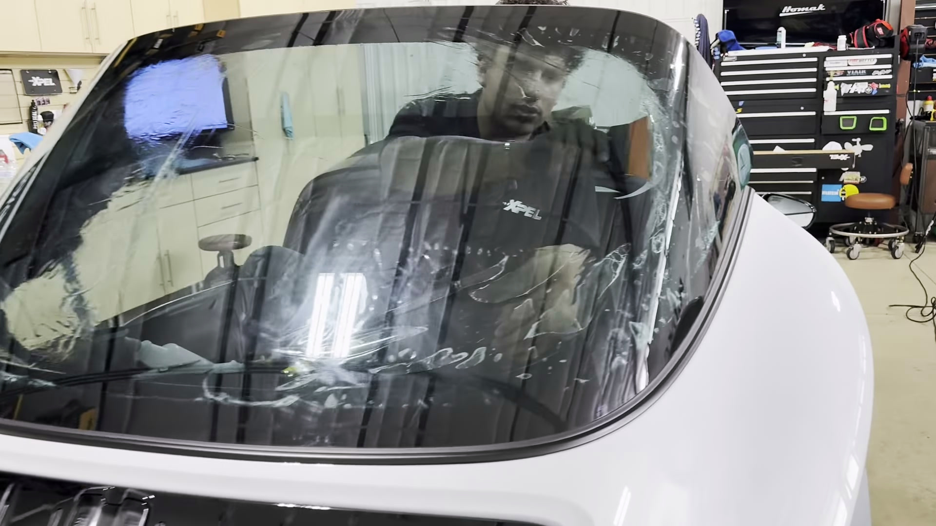Anchor the middle, then work outward Squeegee working outward from the anchored middle of the rear-window film