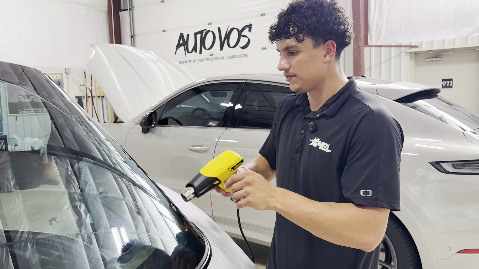 Set the remaining fingers and inspect the edges Heat gun aimed toward the rear glass during the final edge-finishing sequence
