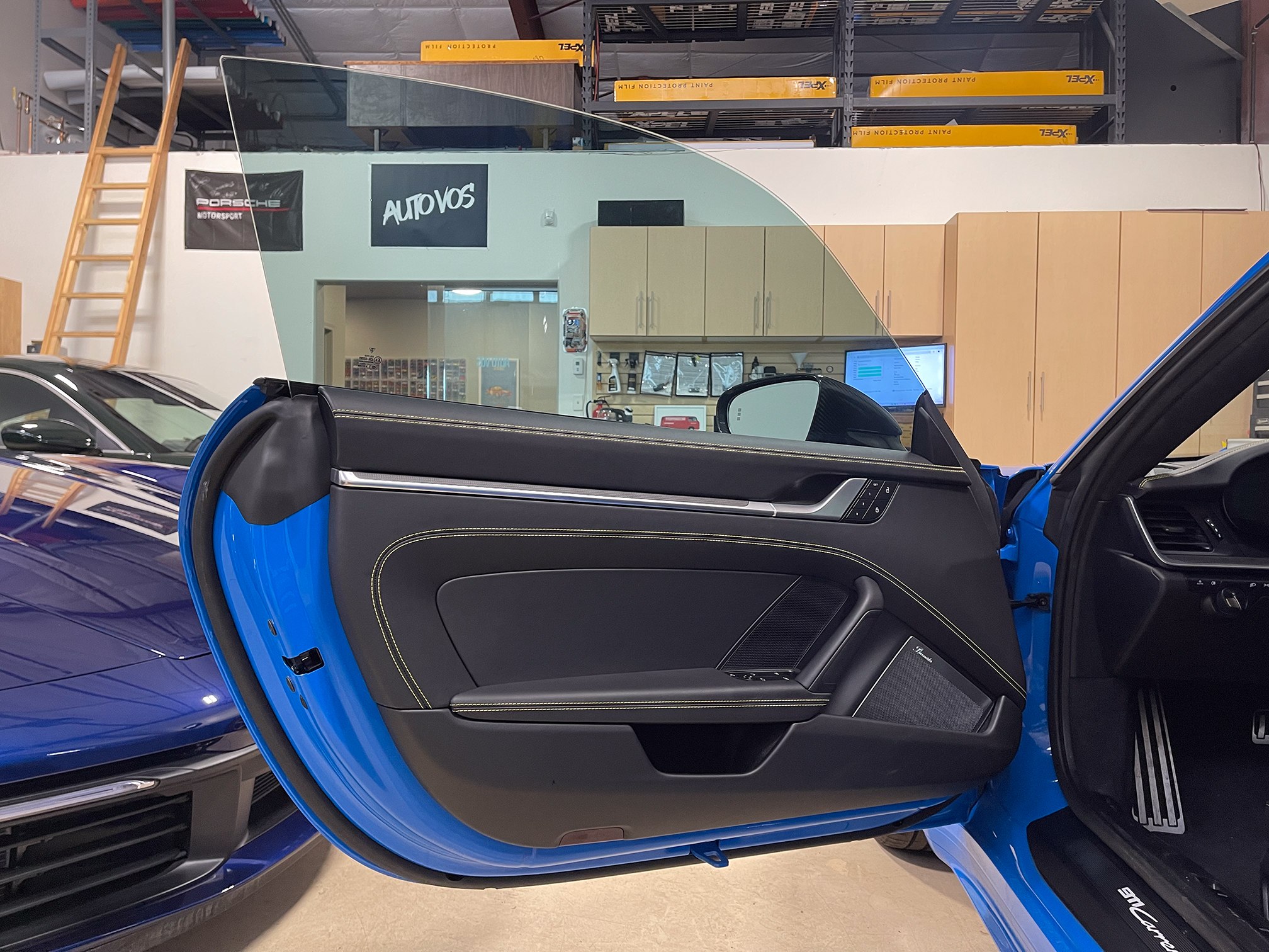 An open blue door gives a clear view of the side glass and cabin An open blue door gives a clear view of the side glass and cabin.