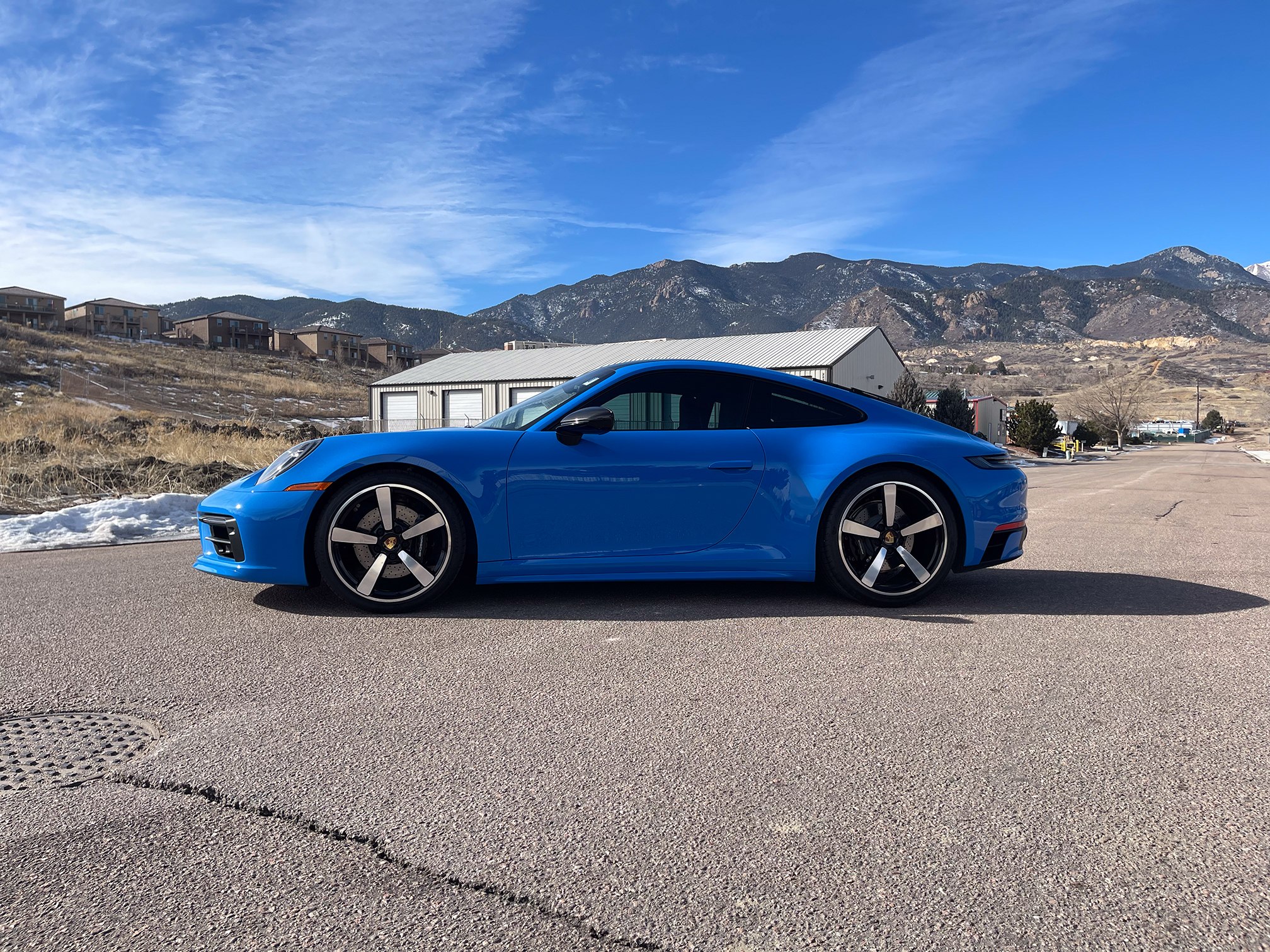 Blue two-door coupe in side profile outside Auto Vos Blue two-door coupe in side profile outside Auto Vos