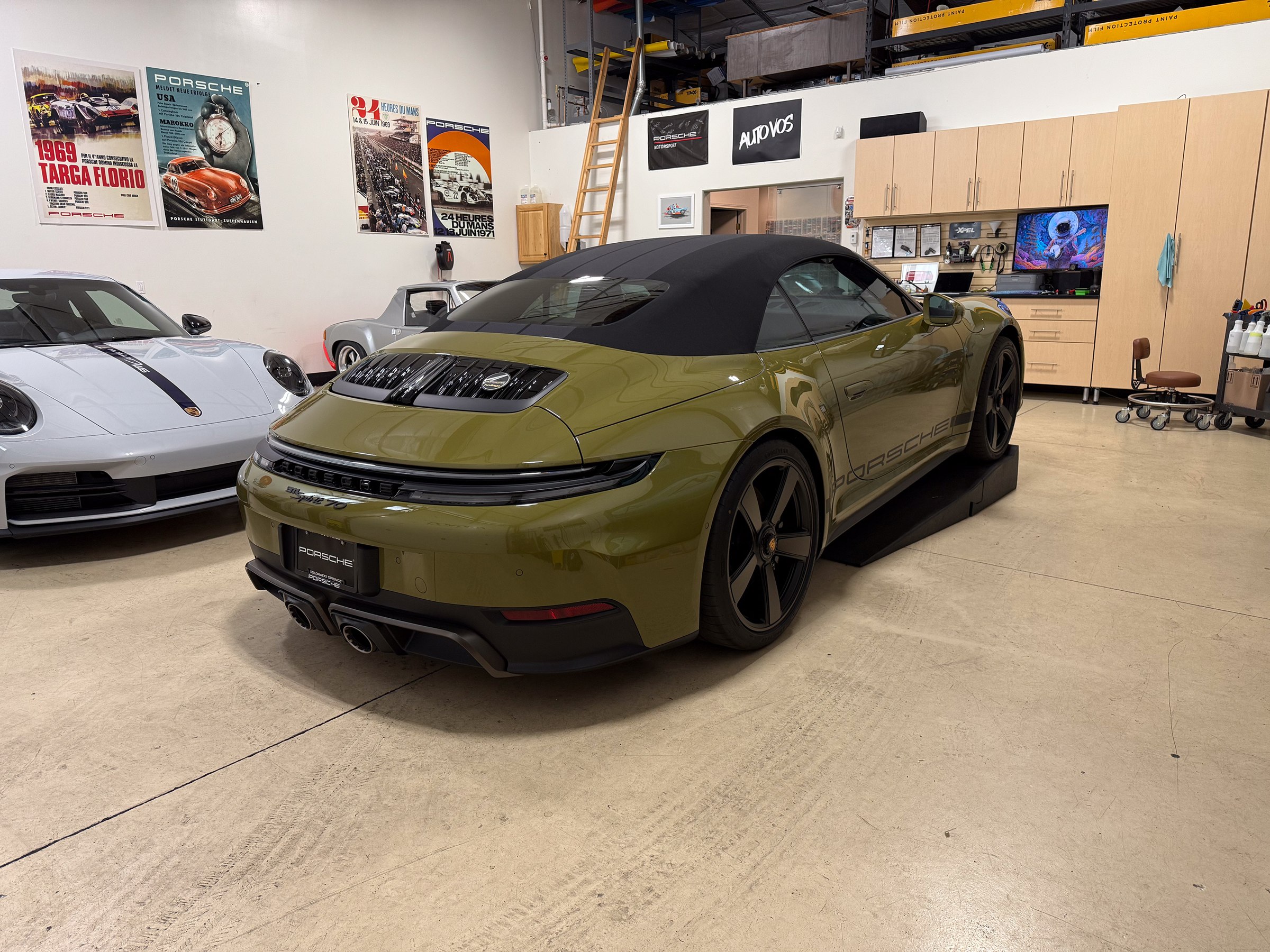An olive-colored sports car photographed inside the studio An olive-colored sports car photographed inside the studio.