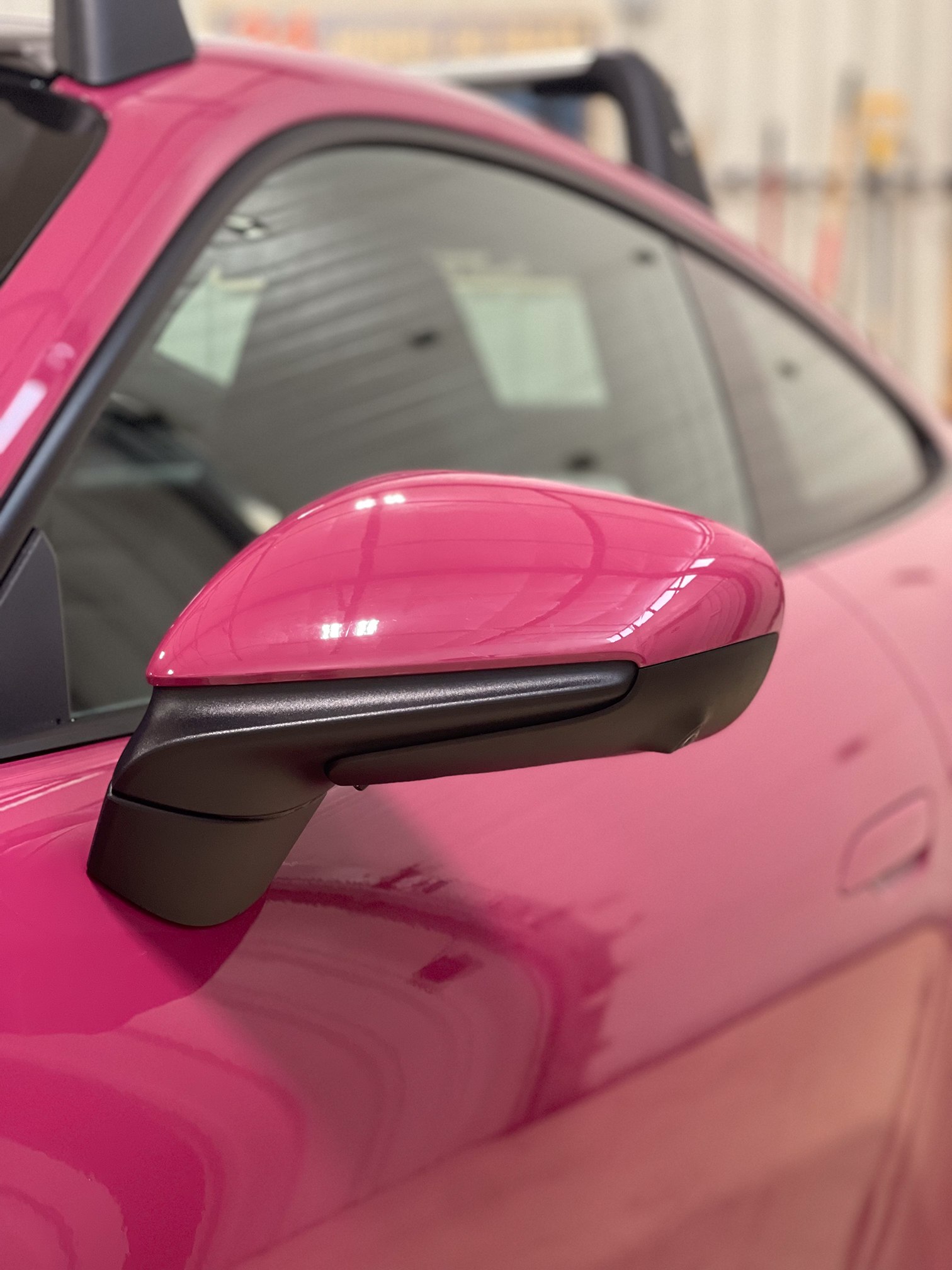 Pink Porsche side mirror and door in the workshop Pink Porsche side mirror and door in the workshop