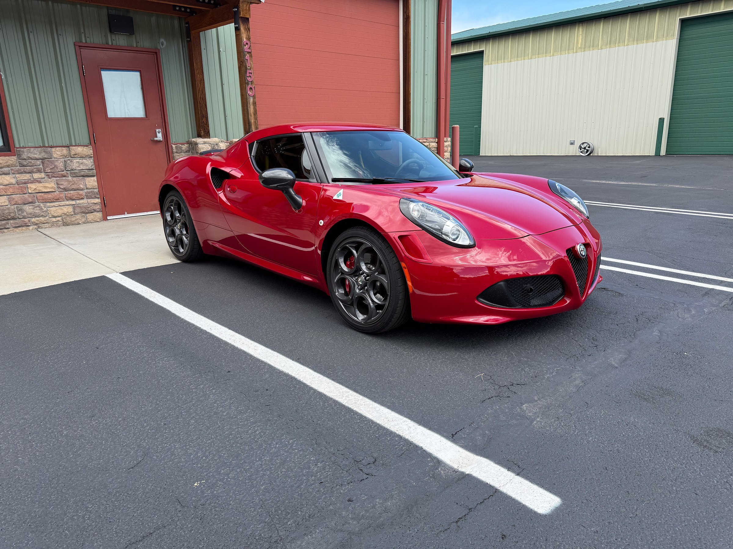 Red Alfa Romeo 4C parked outside Auto Vos Red Alfa Romeo 4C parked outside Auto Vos