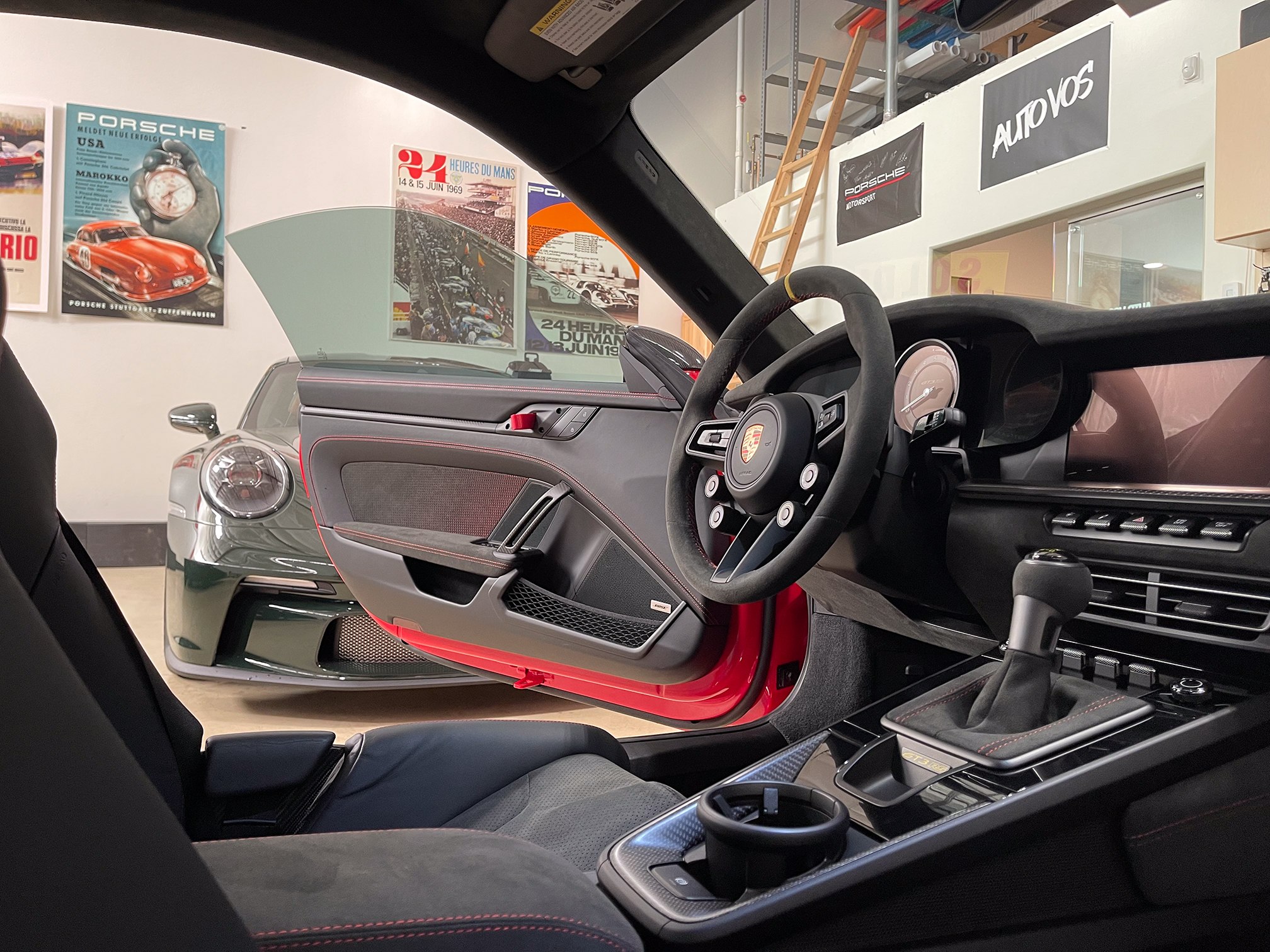 A view into the cabin of a red coupe with the door open A view into the cabin of a red coupe with the door open.