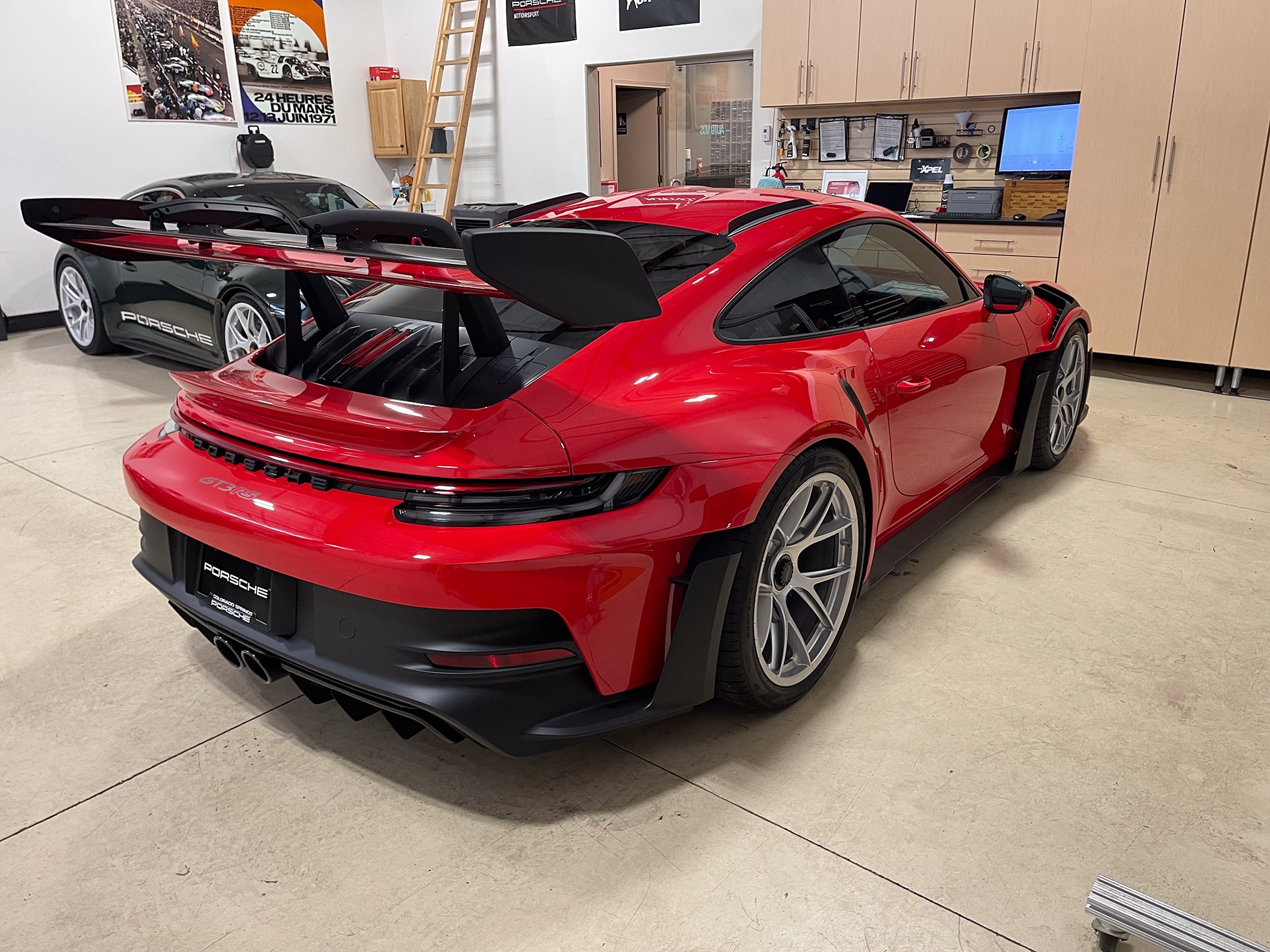Rear wing, glass and taillights of a red Porsche 911 inside Auto Vos Rear wing, glass and taillights of a red Porsche 911 inside Auto Vos