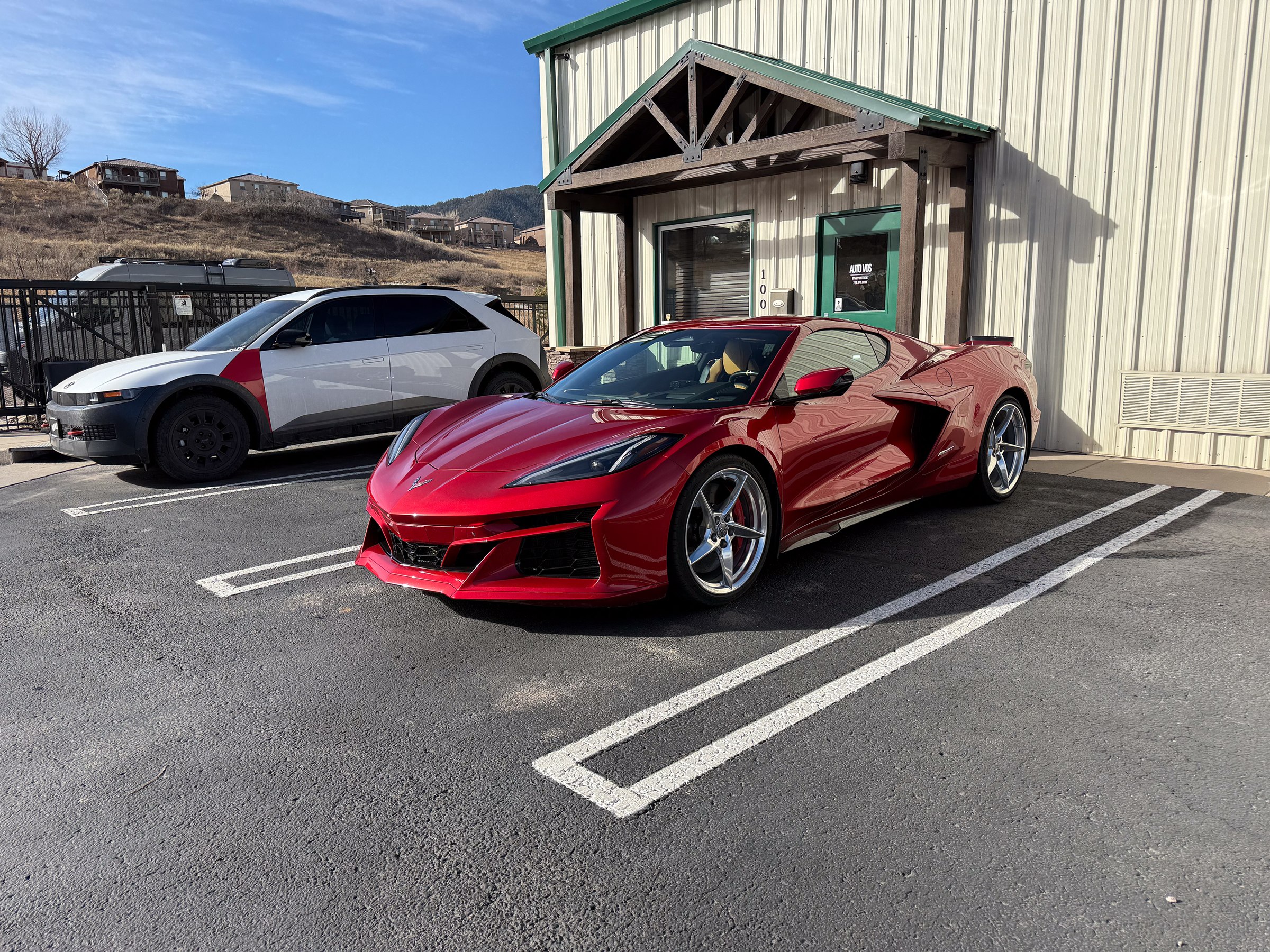Red Chevrolet Corvette outside the Auto Vos entrance Red Chevrolet Corvette outside the Auto Vos entrance