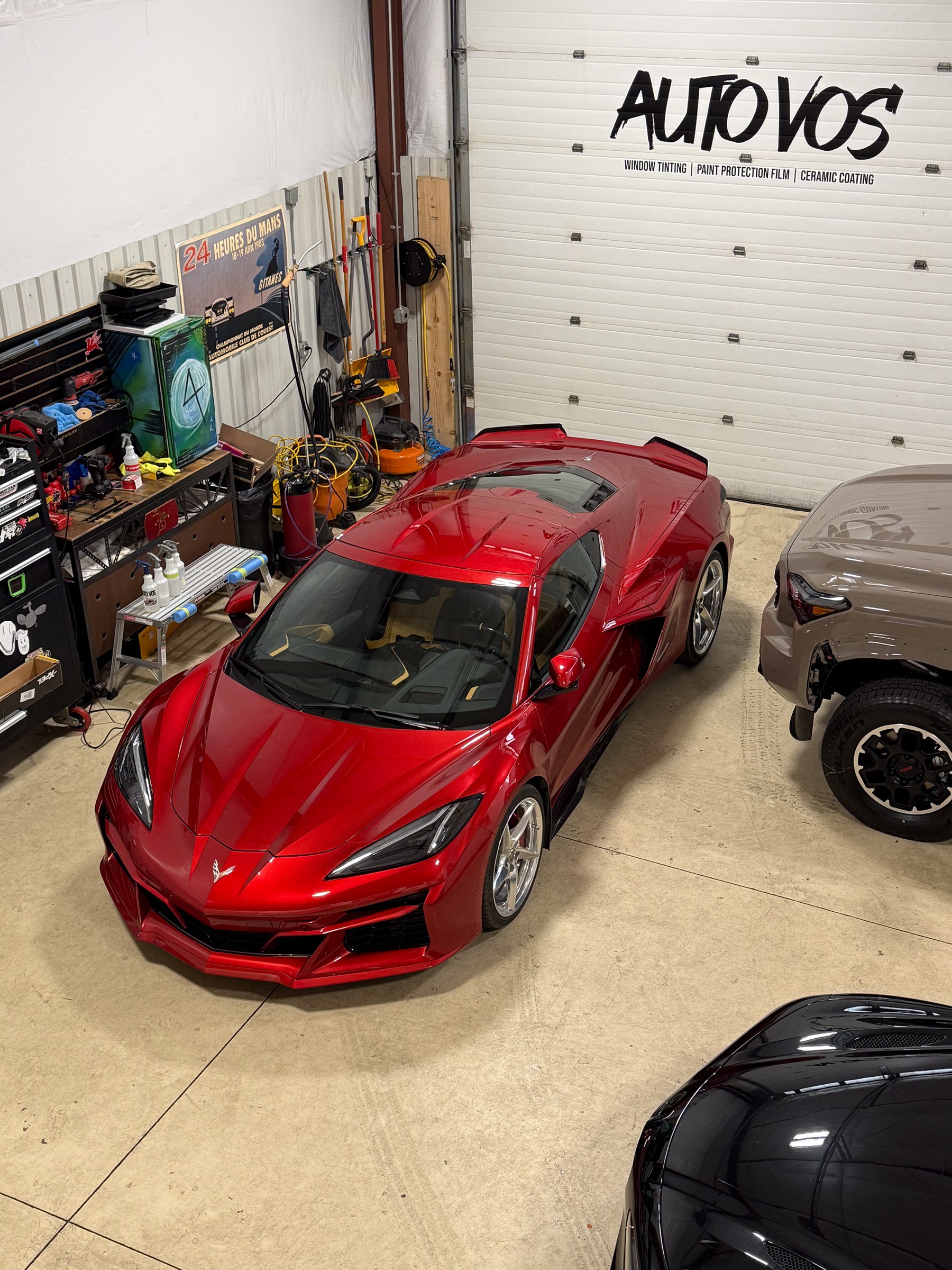 Red Chevrolet Corvette in an Auto Vos work bay Red Chevrolet Corvette in an Auto Vos work bay