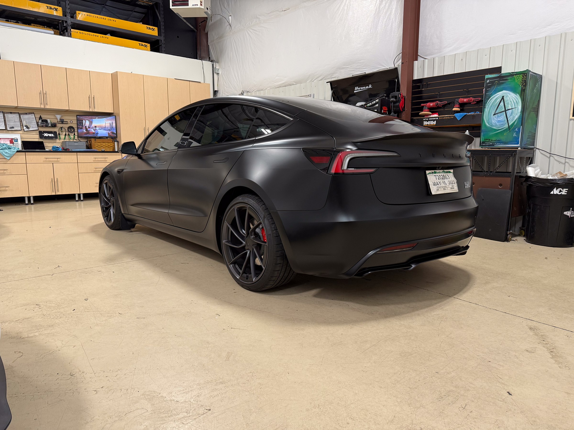 Dark matte Tesla photographed from the rear quarter Dark matte Tesla photographed from the rear quarter
