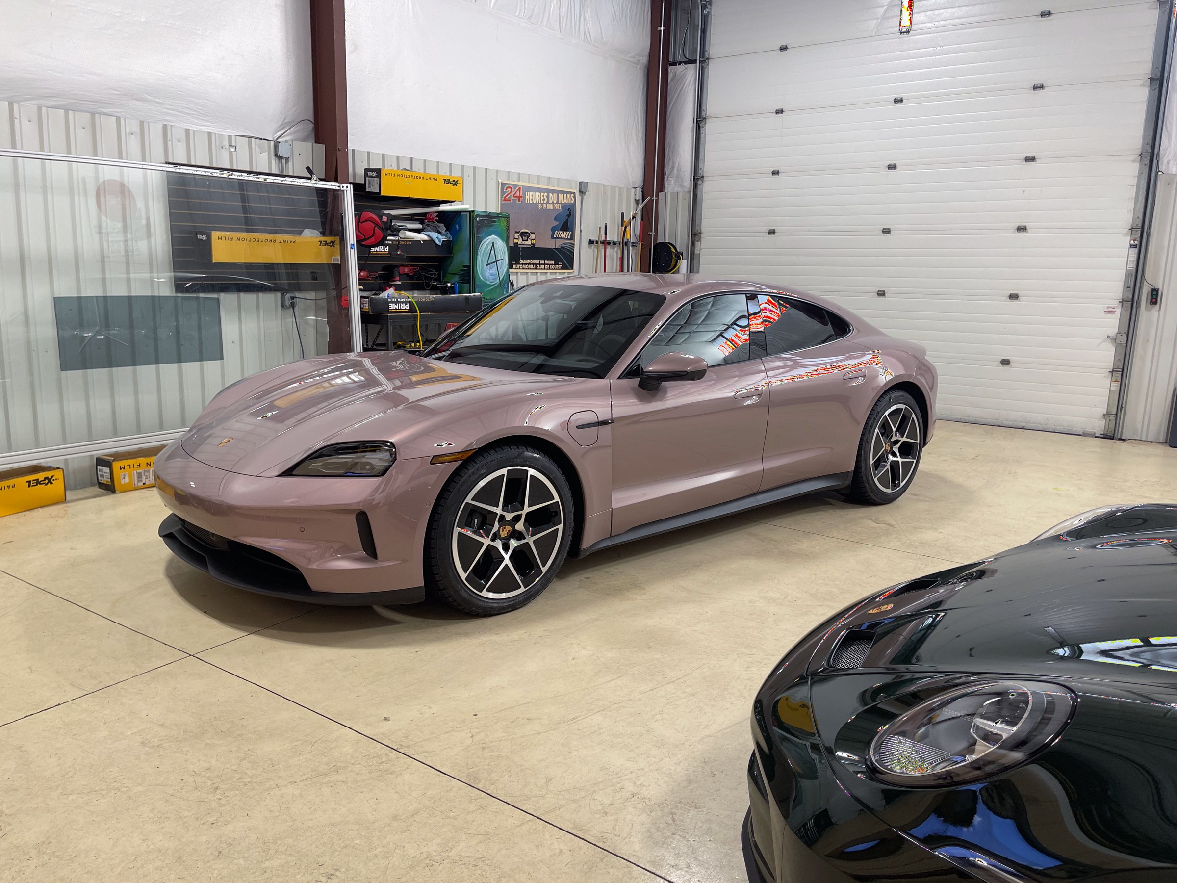 Rose-colored Porsche Taycan with tinted side windows at Auto Vos
